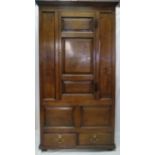 A fantastic 18th Century panelled oak country wardrobe with interior hanging area over two drawers