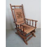 A 19th century mahogany framed rocking chair with tapestry back and seat with turned supports est: