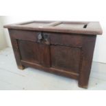 An 18c oak small panelled coffer with one split panel to top over a iron lock plate est: £100-£200