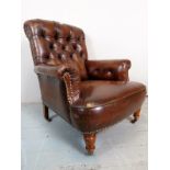 A fine Victorian gentleman's armchair, upholstered in deep button back, brown studded leather,