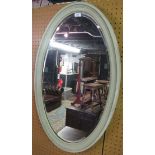A decorative oval framed grey painted wall mirror with beaded edge design and bevelled mirror glass