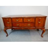 A Queen Anne design walnut sideboard with two central small drawers,