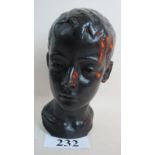 A bronze bust of a child's head, with pa