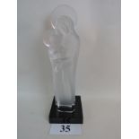 A Lalique frosted glass statue depicting The Madonna and Baby Jesus, signed, black plinth base,
