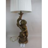 An ornate vintage gilt-plaster table lamp in the form of a cherub holding a cornucopia,