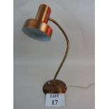 A vintage angle-poise lamp in copper fin