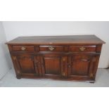 A large Titchmarsh & Goodwin oak sideboard, with three drawers, over three cupboard doors to base,