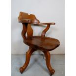 A c1930's solid oak carved Captain's swivel desk chair,