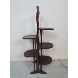 A 20th century mahogany folding double cake stand,