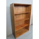 A 19th century pine open bookshelf, with three shelves and with carved beading design,