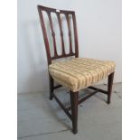 A 19th century mahogany framed chair, upholstered in cream and green stripe material,