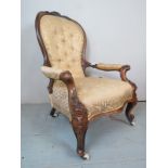 A Victorian carved walnut framed spoon back armchair,