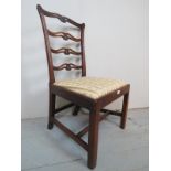 A very pretty Georgian oak framed chair, with a carved back splat, over an upholstered drop in seat,