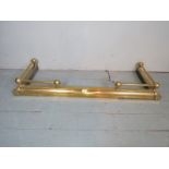 A decorative 20th century brass fire fender,