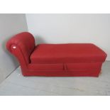 A 20th century Ottoman day-bed, upholstered in red material, and terminating on casters,