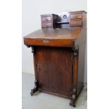 A pretty 19th century oak Davenport desk with four small drawers to top over a leather lift up flap