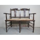 A late 19th century oak framed, two seater settee,