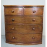 A Victorian mahogany bow front chest of drawers of two short over three long drawers,