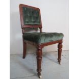 A 19th century carved oak hall chair, upholstered in deep green buttoned material,