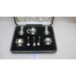 A five piece silver condiment set compri