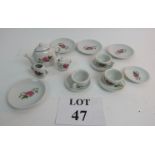 A miniature tea set with four plates, fo
