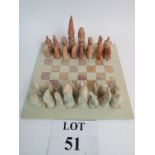 A square soap stone, carved chess set, c