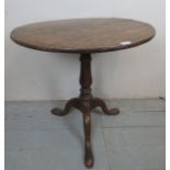 A Georgian oak tripod wine table with a