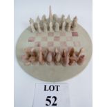 A round soap stone, carved chess set, co