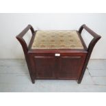 An Edwardian mahogany music stool with a