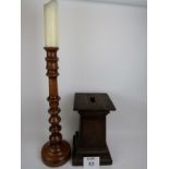 A turned oak candle stand, 72 cm high, and an oak pedestal,