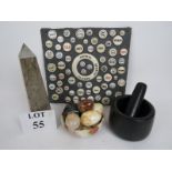 A marble obelisk, a polished stone pestle and mortar,