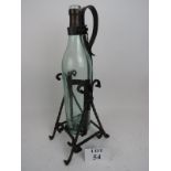 A German 'Asbach Uralt' wrought iron brandy cradle, with bottle, pivots to enable pouring,