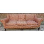 A large 19th Century three seater sofa with loose cushions and covers (worn) and terminating on