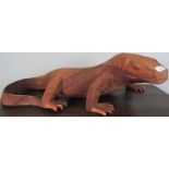 A fine hand carved gecko/lizard with intricate carving and muscle tone definition,