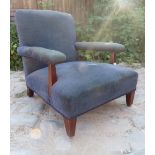 A 19th Century low fireside armchair upholstered in blue material est: £40-£60