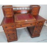 A fine Victorian mahogany 'Dicken's' desk with a central writing slope flanked either side by