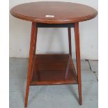 An Edwardian mahogany inlaid circular lamp table with a lower shelf with inlaid shell motif to