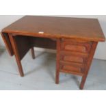 An early 20th Century oak kneehole desk with a brushing slide over three drawers and bearing label