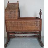 A decorative 19th Century mahogany Bergere child's crib / cot with turned stretchers and supports