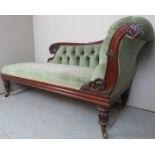 A fine Victorian carved mahogany framed chaise lounge upholstered in pale green buttoned material