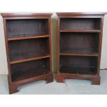 A pair of Edwardian mahogany small open bookcases each with two adjustable shelves and terminating