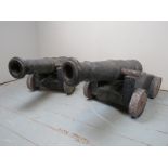 A fantastic pair of early 19th Century naval deck cannons each with raised crests and mounted on