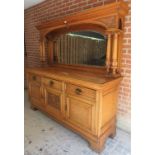 A Victorian pale oak mirror back sideboard with a bevelled edge glass over drawers and cupboards