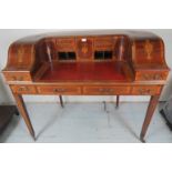 An excellent quality Edwardian marquetry inlaid Carlton House desk with a curved top over a red