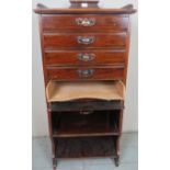 An Edwardian mahogany sheet music cabinet with five fall front drawers beneath a gallery rail to