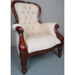 A good quality 20th Century Victorian design button back armchair with a carved mahogany frame and