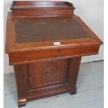 An Edwardian mahogany davenport desk with a fitted top compartment over a lift up writing area and