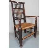 A 19th Century oak and elm country armchair with turned spindles to back over a rush seat and a