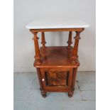 A Victorian walnut lamp table with cream