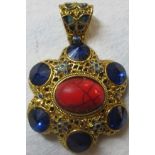 An eastern pendant inset with blue stone